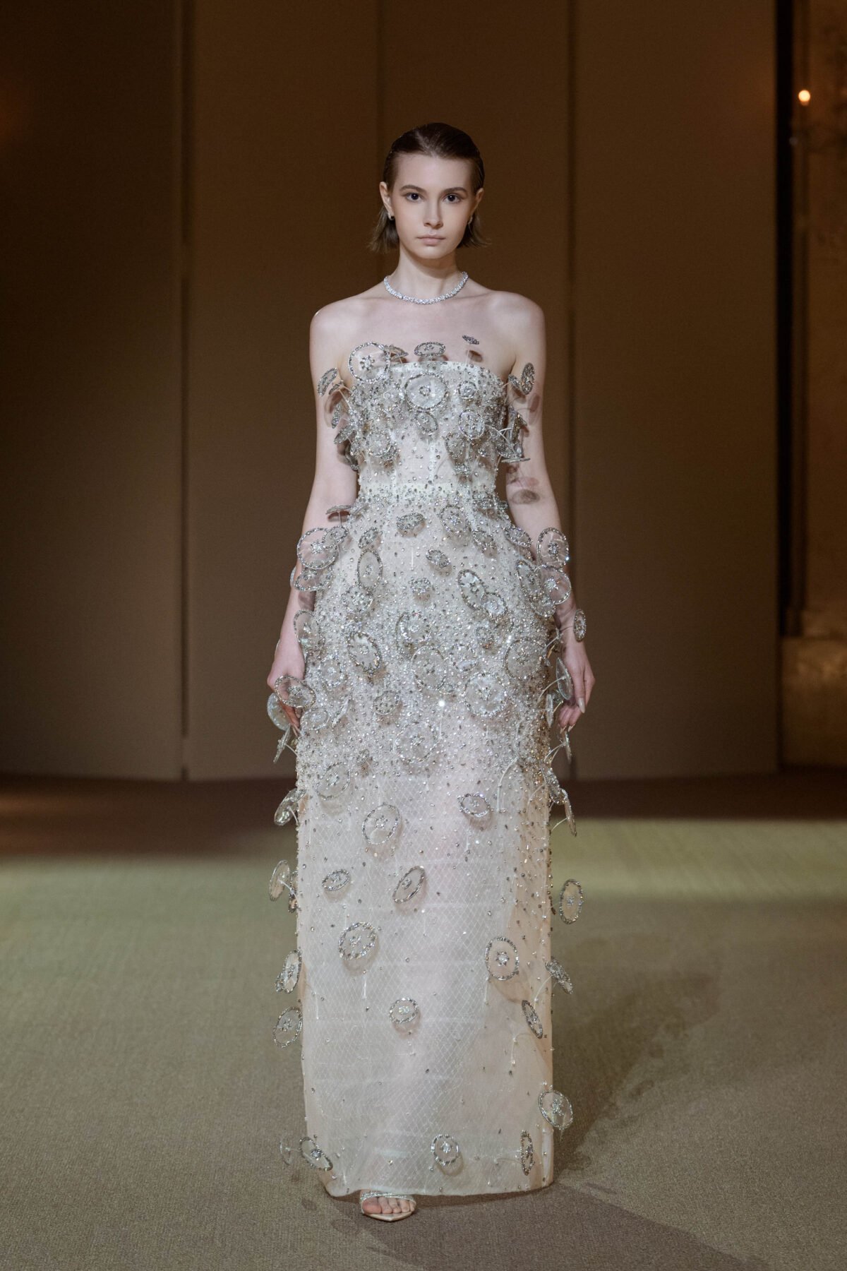Silvery white column dress with three-dimensional circular disc embellishment